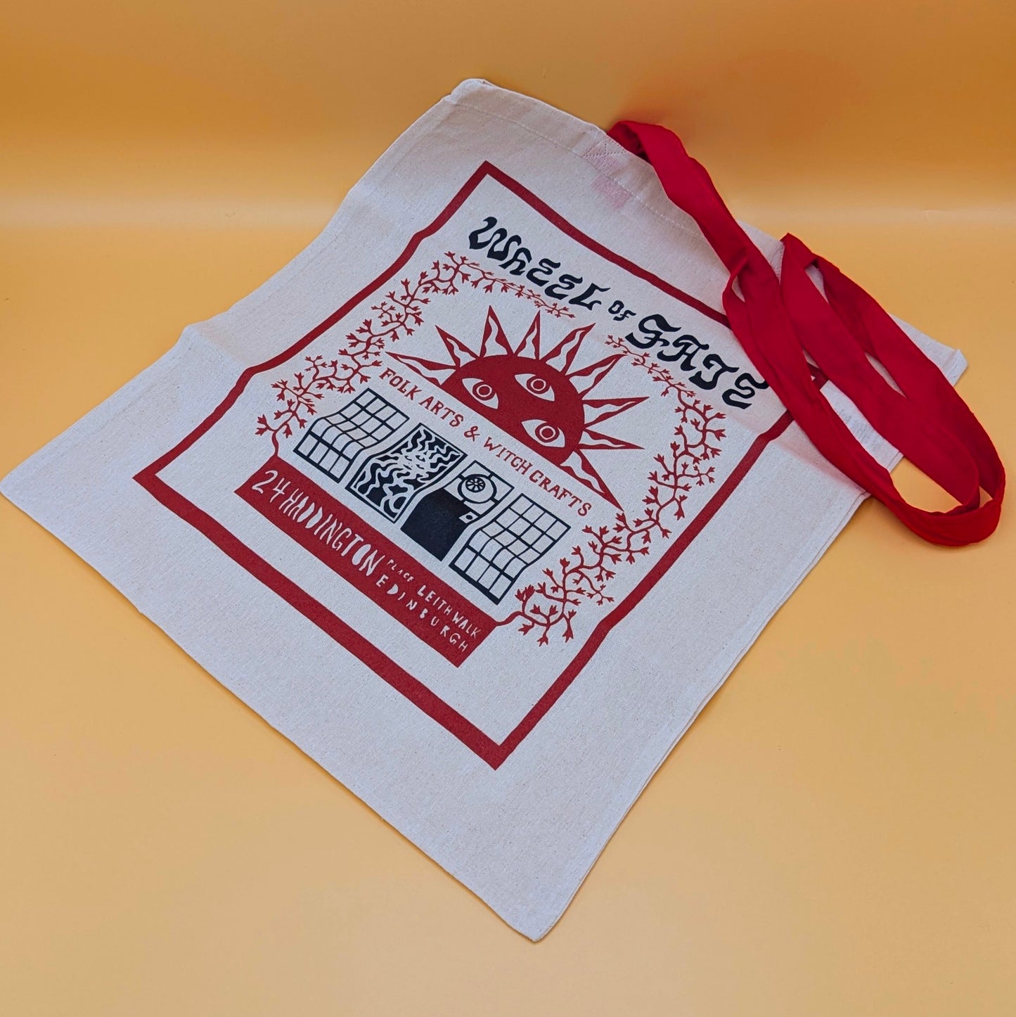 Wheel of Fate Sun Tote: Red-Handled Flat Tote Bag