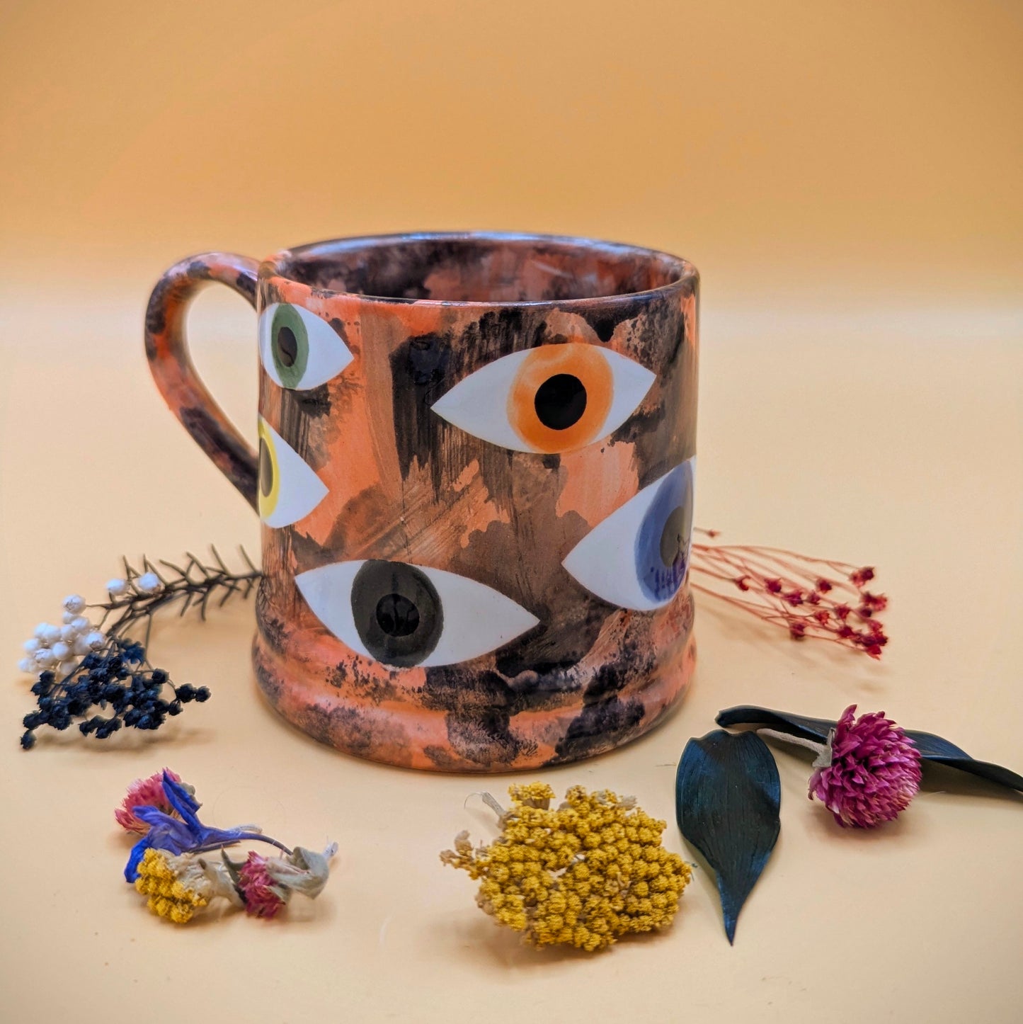 'Multi Eye on Orange' Ceramic Mug by Ciara Veronica Dunne