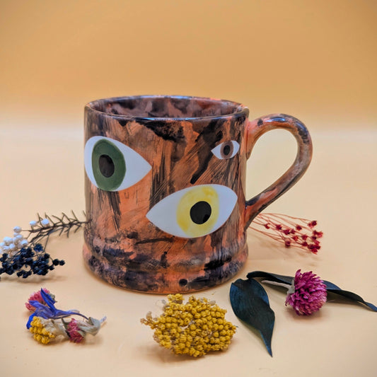 'Multi Eye on Orange' Ceramic Mug by Ciara Veronica Dunne
