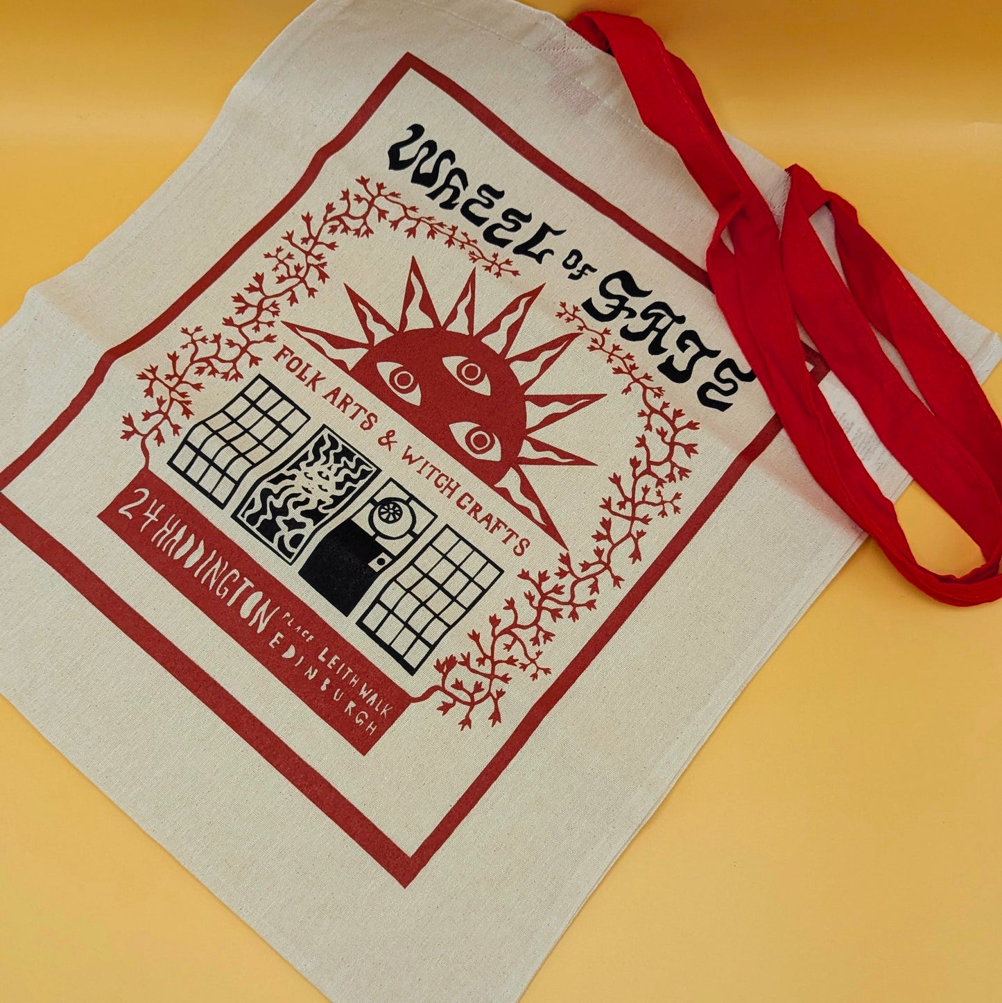 Wheel of Fate Sun Tote: Red-Handled Flat Tote Bag